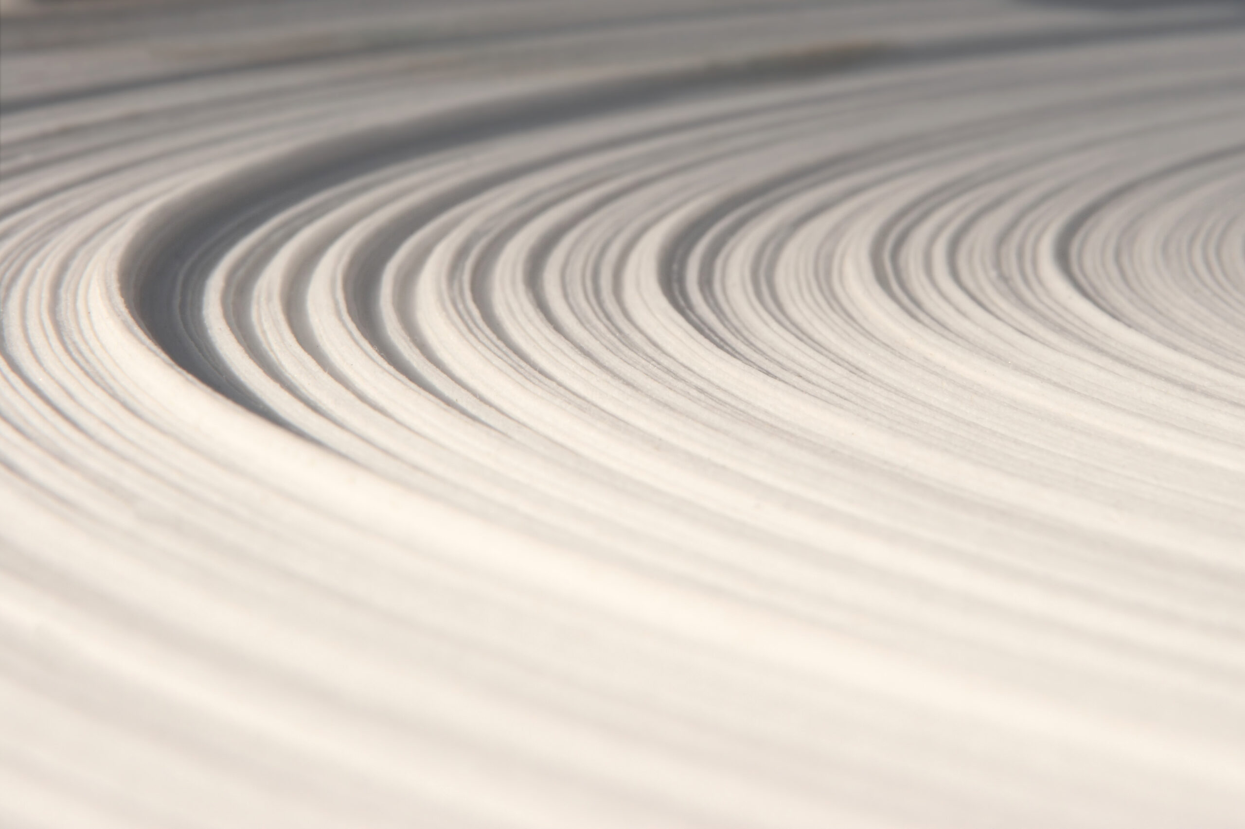 Paper roll close-up Close-up view of wet paper pulp fibers in a manufacturing process."